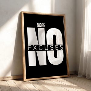 May include: A rectangular wall art print in a light wood frame featuring a black background with the white text MORE NO EXCUSES. The word NO is displayed in large, bold, white capital letters, while the words MORE and EXCUSES are smaller.