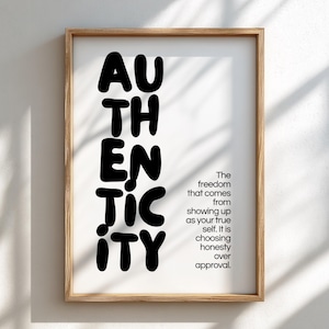 May include: A framed wall art print featuring the word AUTHENTICITY in large, bold, black sans-serif letters stacked vertically. To the right, smaller black text reads: The freedom that comes from showing up as your true self. It is choosing honesty over approval.