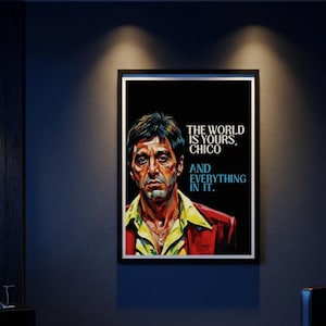 May include: Framed art print featuring a portrait of a man in a red jacket and yellow shirt. The black background has the text "THE WORLD IS YOURS, CHICO, AND EVERYTHING IN IT."