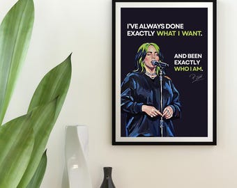May include: A framed art print featuring a portrait of a singer with green and black hair, holding a microphone. The print includes the text "I'VE ALWAYS DONE EXACTLY WHAT I WANT. AND BEEN EXACTLY WHO I AM."