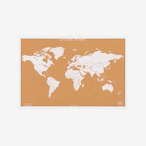 May include: A rectangular cork world map with a white frame. The map shows continents in white against a tan background. The text "LET'S TRAVEL THE WORLD" is printed at the top. The map is a decorative item for travel enthusiasts.