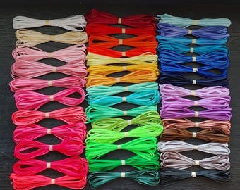 May include: An assortment of 41 colors of 1/8 inch ribbon, neatly bundled and secured with rubber bands. The ribbons span a wide spectrum of hues, from pastels to vibrant shades, including pinks, blues, greens, and reds. Text reads "Hairbow Supplies, Etc."