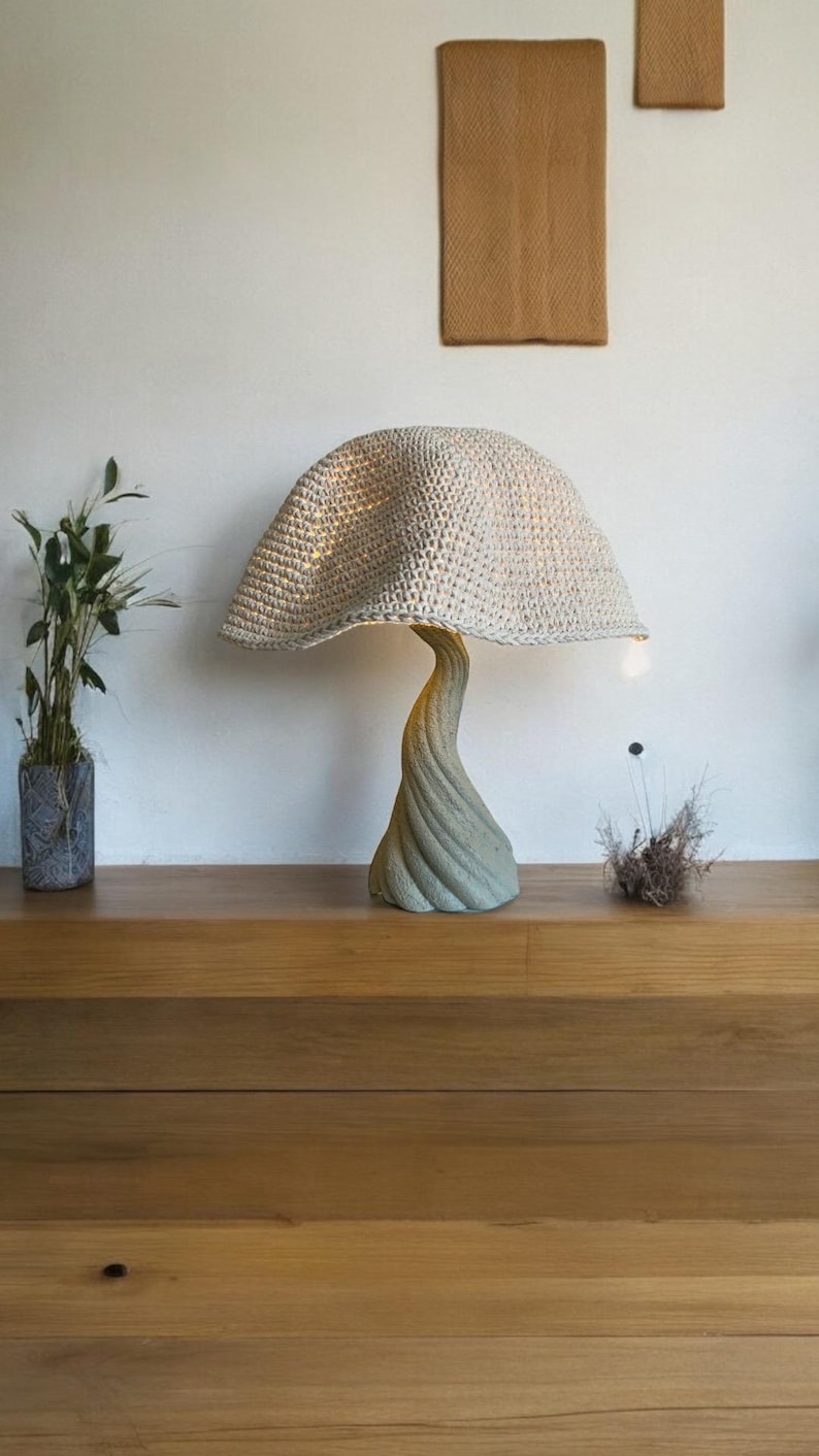 Handmade mushroom lamp featuring a soft woven shade and sculptural curved base in natural tones. Cozy warm light adds a Japandi-inspired, organic feel to any space.