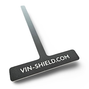 May include: A black and white T-shaped product with the text VIN-SHIELD.COM. The product has a long, thin handle and a wider rectangular base. The background is white.
