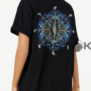 May include: Black t-shirt with a vibrant, detailed design on the back. The design is a symmetrical, abstract pattern with blue, green, and yellow tones. The shirt has short sleeves and a loose fit.
