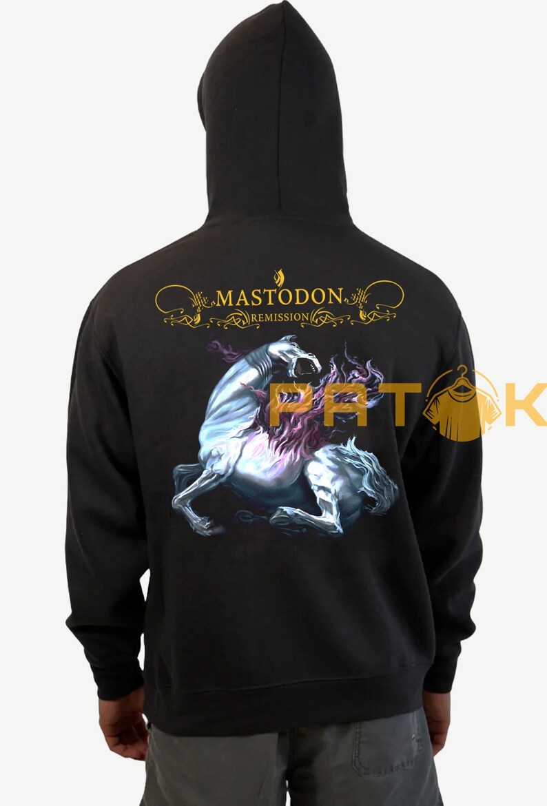 May include: Black hoodie featuring the band name "Mastodon" and album title "Remission" in gold lettering. The back displays a detailed illustration of a mythical creature. The hoodie has a hood and long sleeves.