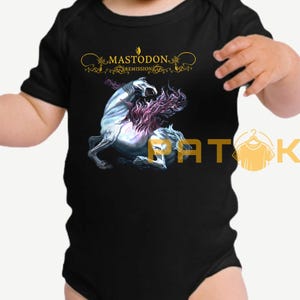 May include: Black baby bodysuit featuring a graphic of a white horse with purple mane and the text "MASTODON REMISSION" in gold. The bodysuit is short-sleeved and has a round neckline.