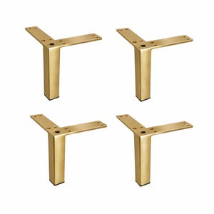 May include: Four gold-colored furniture legs in a Y-shape. Each leg has a rectangular base and a flat top with pre-drilled holes for mounting. The legs are made of metal and have a brushed finish.