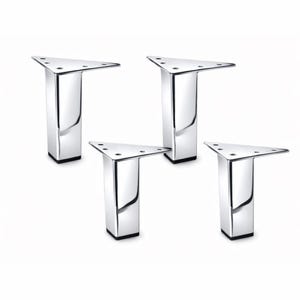 May include: Four chrome-finished furniture legs. Each leg has a triangular top with screw holes and a rectangular base. The legs are reflective, with a shiny, polished appearance. The bases are black.