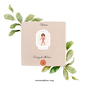 May include: A square, tan sticker sheet with the text "Stickers" at the top. A sticker with a woman in a pink suit and the words "I manifest. I execute." is in the center. The words "Designed with love" are below the sticker. Green leaves surround the sheet.