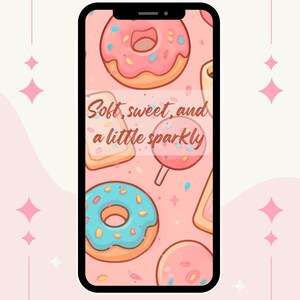 May include: A pink and white graphic with the text "New Arrival wallpaper." The image features a phone displaying a pattern of donuts, a lollipop, and toast. Text on the phone reads "Soft, sweet, and a little sparkly." The bottom text says "Our newest product grab it while you can!"