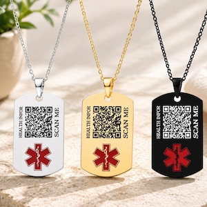 May include: Three dog tag necklaces in silver, gold, and black tones. Each pendant features a QR code, the text "HEALTH INFOR" and "SCAN ME," and a red Star of Life medical symbol. The pendants hang from matching metal chains.