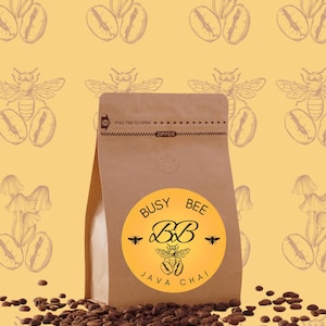 May include: A brown paper bag of Busy Bee Java Chai coffee, with a yellow circular label. The label features the text "Busy Bee Java Chai" and a bee illustration. Coffee beans are scattered in front of the bag. The background is yellow with a repeating pattern.
