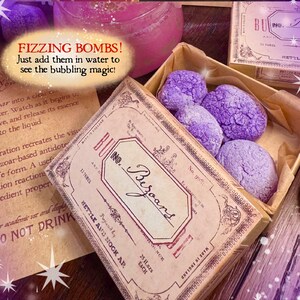May include: A box of purple, textured fizzing bombs, with a vintage-style label that reads "No. Bezoars." The image includes a handwritten note with instructions and the text "Fizzing Bombs!" in a bubble.