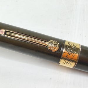 May include: A set of three ceramic mugs with a speckled, matte finish. The mugs are in shades of cream, light gray, and dark gray. Each mug has a simple, minimalist design and a rounded handle.