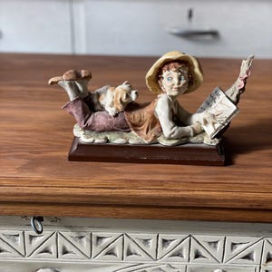 Vintage Figurine of Boy and Dog – A Whimsical Countryside Scene
