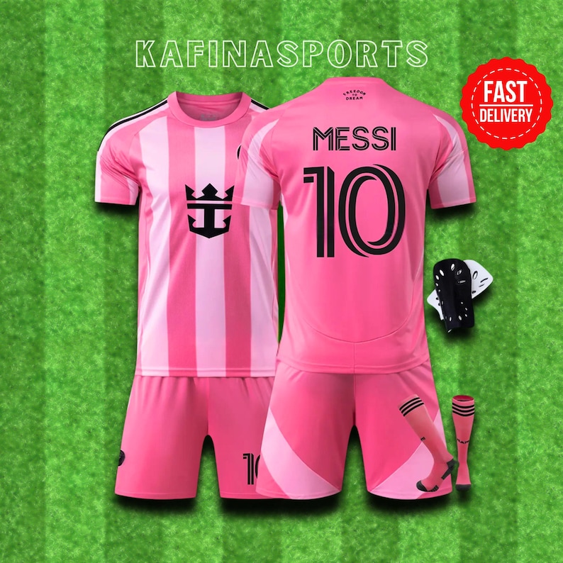 May include: Pink soccer uniform set with the name "MESSI" and the number "10" on the back. The set includes a jersey, shorts, and socks. The jersey has a striped design on the front and the text "KAFINASPORTS" at the top.