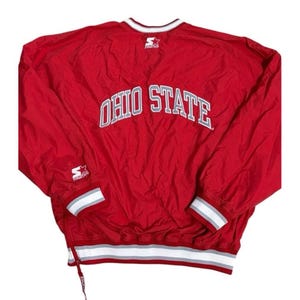 May include: Red Starter Ohio State jacket with white and gray accents. The jacket features the words "OHIO STATE" in large, white, block letters across the back. The Starter logo is visible on the sleeve and neckline.