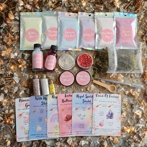 May include: A collection of craft supplies, including small bottles, jars, and packets of colorful powders and glitter. The set includes cards with text such as "Princess Garden" and "Crown of Courage". The items are arranged on a textured surface.