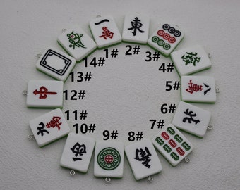 May include: A set of 14 white and green mahjong tiles with black and red Chinese characters and symbols. The tiles are numbered 1 through 14 and are arranged in a circle.
