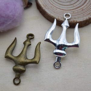 May include: Two trident charms, one silver and one bronze, with a loop at the top for attaching to jewelry or other crafts.