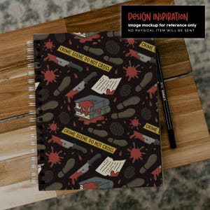 May include: Spiral-bound notebook with a dark background featuring a crime scene design. The pattern includes blood splatters, knives, footprints, fingerprints, and the text "CRIME SCENE DO NOT CROSS". A black pen rests on the side. The text "DESIGN INSPIRATION" is also visible.