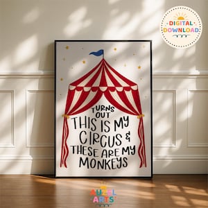May include: A framed wall art print featuring a red and white striped circus tent illustration with a blue flag on top and yellow stars. The text reads: TURNS OUT THIS IS MY CIRCUS & THESE ARE MY MONKEYS. The design is on a white background.