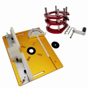 May include: A woodworking router table with a gold-colored base, a white fence, and a silver protractor. A red router lift and a black disc are also included. A silver wrench and other hardware are also visible.