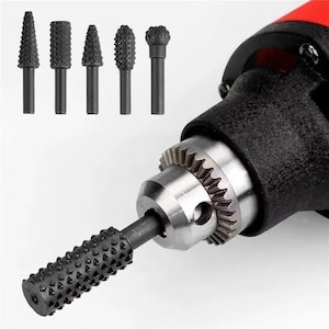 May include: A selection of five black rotary burr bits with different shapes and textures, and a black and red power tool. The burr bits are designed for shaping, grinding, and removing material from various surfaces.