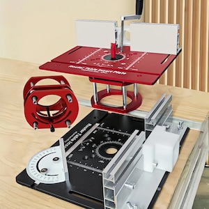 May include: A red router table insert plate with a black base and a silver handle. The table has a circular design with measurements in inches. A red router lift and a black fence are also visible.