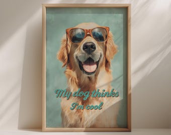 Puede incluir: Impresión enmarcada de un Golden Retriever con gafas de sol y sonriendo. El texto "My dog thinks I'm cool" está escrito en turquesa debajo del perro. El marco es de madera clara.