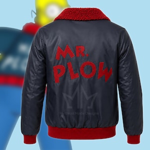 May include: A navy blue bomber jacket featuring a red sherpa collar, red ribbed cuffs, and a red ribbed hem. The back of the jacket displays the red embroidered text "MR. PLOW" in a bold font, with a faint "Mythical Made Designs" logo below it.