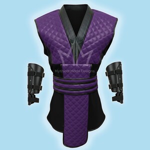 May include: A purple and black costume with diamond-patterned accents. The costume includes a vest, belt, and two arm guards. The vest has a quilted design and a black collar. The text "Mythical Made Designs" is visible.