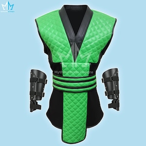 May include: A green and black costume with diamond-patterned padding, a V-neck, and a black belt. Includes black arm guards with straps. The costume has the text "Mythical Made Designs".