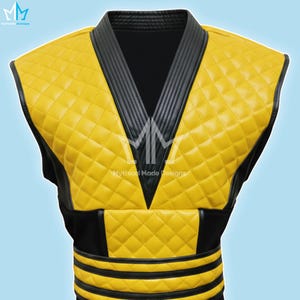 May include: A yellow quilted vest with black trim and accents. The vest features a diamond pattern and a V-neck design. The text "Mythical Made Designs" is visible on the vest.
