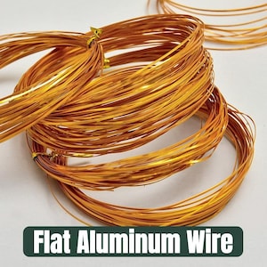 May include: Close-up of several coils of flat, gold-colored aluminum wire. The wire is tightly wound into circular shapes, with some strands extending outwards. The text "Flat Aluminum Wire" is displayed in a green rectangle at the bottom.