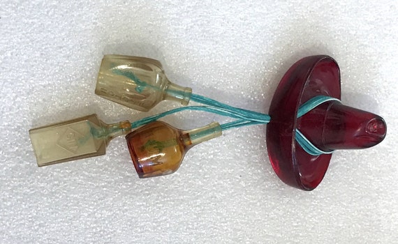 Vintage celluloid hat & bottles pin brooch