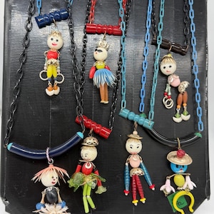 Vintage style necklace - 1950s  Israeli crib toy doll dangling on Galalite piece