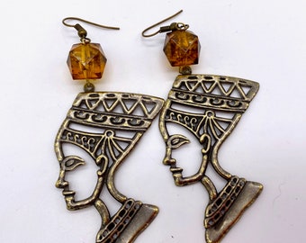 Vintage metal and early plastic Egyptian revival piercing earrings