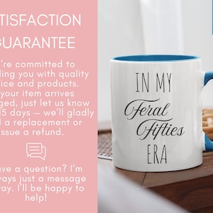 May include: A white ceramic mug with a light blue interior and handle, featuring the black text 'IN MY Feral Fifties ERA' printed on the front. The mug has an 11 oz capacity as indicated by the blue tag in the upper right corner of the image.