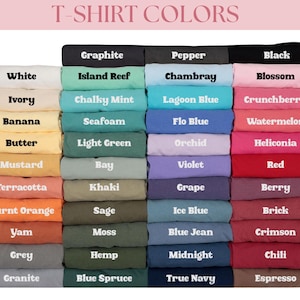 May include: A color chart displaying folded t-shirts in various shades labeled with text including White, Ivory, Banana, Butter, Mustard, Terracotta, Burnt Orange, Yam, Grey, Granite, Graphite, Island Reef, Chalky Mint, Seafoam, Light Green, Bay, Khaki, Sage, Moss, Hemp, Blue Spruce, Pepper, Chambray, Lagoon Blue, Flo Blue, Orchid, Violet, Grape, Ice Blue, Blue Jean, Midnight, True Navy, Black, Blossom, Crunchberry, Watermelon, Heliconia, Red, Berry, Brick, Crimson, Chili, and Espresso.