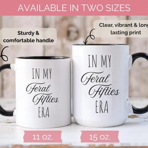 May include: Two white ceramic mugs with black handles and rims. The mugs have the text "IN MY Feral Fifties ERA" in black script. One mug is 11 oz, the other is 15 oz. The mugs are labeled as having a sturdy and comfortable handle and a clear, vibrant, and long-lasting print.