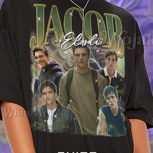 May include: Black unisex t-shirt featuring a graphic of Jacob Elordi with the name in gold lettering. The shirt includes multiple images of the actor. Text at the bottom reads "SHIRT Unisex".