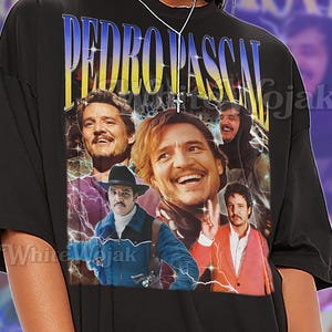May include: Black unisex t-shirt featuring a collage of images of Pedro Pascal with the text "PEDRO PASCAL" in a blue and yellow design. The shirt also has the text "SHIRT Unisex".