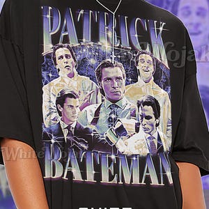 May include: Black unisex t-shirt featuring a graphic of Patrick Bateman from the movie "American Psycho". The design includes the name "PATRICK BATEMAN" in a stylized font, with multiple images of the character. The shirt also has the word "Unisex" printed on it.