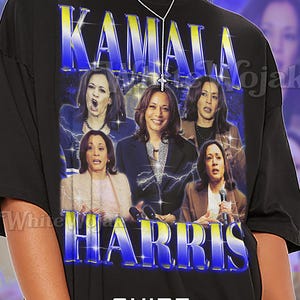 May include: Black unisex t-shirt featuring a graphic of Kamala Harris with the text "KAMALA HARRIS" in a blue and yellow design. The shirt has a crew neck and short sleeves. The word "Unisex" is printed on the shirt.