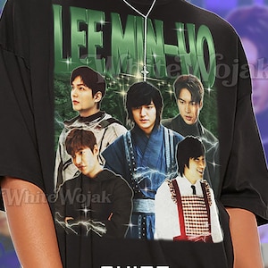 May include: Black unisex t-shirt featuring a graphic of Lee Min-ho with the text "LEE MIN-HO" in green. The shirt also has the text "White Wojak" and "SHIRT Unisex". The shirt is described as fitting true to size.