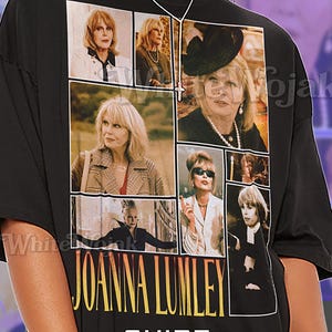 May include: Black unisex t-shirt featuring a collage of images of Joanna Lumley. The shirt has the name "JOANNA LUMLEY" in large yellow letters and the word "SHIRT" and "Unisex" in white. The shirt is made of a soft material.