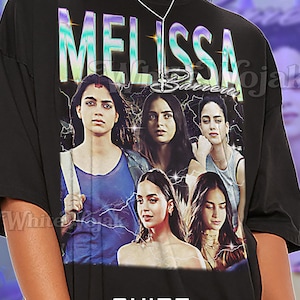 May include: Black unisex t-shirt featuring the name "MELISSA" in a colorful, stylized font above a graphic of five women. The shirt includes the text "SHIRT Unisex" at the bottom.