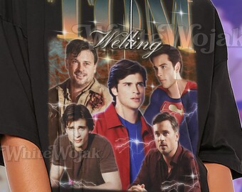 May include: Black unisex t-shirt featuring a collage of actors with the text "TOM Welting Wojak". The shirt has a vintage aesthetic with a distressed design. The text "SHIRT Unisex" is printed at the bottom.
